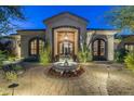 Inviting entryway with a fountain and ornate doors at 7130 E Berneil Ln, Paradise Valley, AZ 85253