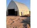 Large metal barn with open front, showing signs of wear at 735 S Ruby Rd, Maricopa, AZ 85139