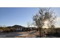 A small house with a covered patio, situated on a desert lot at 735 S Ruby Rd, Maricopa, AZ 85139