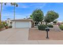 Charming single story home with a two car garage and desert landscaping at 947 N 85Th Pl, Scottsdale, AZ 85257
