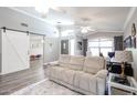 Spacious living room featuring hardwood floors and sliding glass doors at 10405 W Patrick Ln, Peoria, AZ 85383