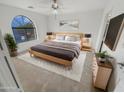 Bright bedroom with a large window and wooden bed frame at 11436 W Austin Thomas Dr, Surprise, AZ 85378