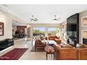 Open living room with a fireplace, large windows, and ample seating at 12544 N 120Th Pl, Scottsdale, AZ 85259
