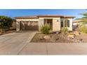 Single-story home with desert landscaping and two-car garage at 13162 W Duane Ln, Peoria, AZ 85383