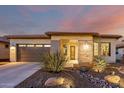 Single story home with a two-car garage and drought-tolerant landscaping at 13162 W Duane Ln, Peoria, AZ 85383
