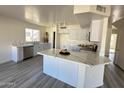 Modern kitchen with white cabinets and marble countertops at 13620 W San Juan Ave, Litchfield Park, AZ 85340