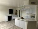 Modern kitchen with white cabinets and marble countertops at 13620 W San Juan Ave, Litchfield Park, AZ 85340