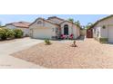 Charming single-story home with desert landscaping, cozy seating, and a two-car garage at 15306 W Eureka Trl, Surprise, AZ 85374