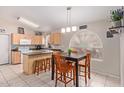 Bright kitchen with an island and breakfast bar, offering ample counter space at 15306 W Eureka Trl, Surprise, AZ 85374