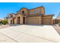 Two-story house with stone accents and a three-car garage at 16109 W Christy Dr, Surprise, AZ 85379
