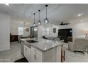 Open concept kitchen with large island and granite countertops at 19945 W Badgett Ln, Litchfield Park, AZ 85340