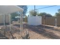 Small backyard with gravel, storage shed, and partial view of a fence at 201 S Greenfield Rd # 16, Mesa, AZ 85206