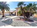 Another view of the home's exterior, highlighting the landscaping and walkway at 21214 N 124Th Ave, Sun City West, AZ 85375