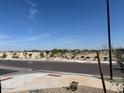 View of the neighborhood park with walking trails, scattered trees, and an open green space at 22563 W Pontiac Dr, Surprise, AZ 85387