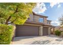 Two-story house with brown double garage doors and desert landscaping at 2527 W Kit Carson Trl, Phoenix, AZ 85086