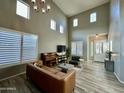 Living room with high ceilings, hardwood floors, and a piano at 2527 W Kit Carson Trl, Phoenix, AZ 85086