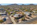 Aerial view showcasing a large house, expansive property, and surrounding neighborhood at 2625 W Desert Hills Dr, Phoenix, AZ 85086