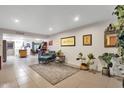 Bright and airy living room with tile floors and a view into the kitchen at 3310 W Christy Dr, Phoenix, AZ 85029