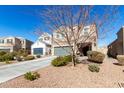 Two-story house with gray garage door and landscaping at 4726 E Chromium Rd, San Tan Valley, AZ 85143