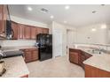 Well-lit kitchen with stainless steel appliances, granite countertops, and abundant cabinet space at 6546 W Georgetown Way, Florence, AZ 85132