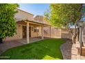 Backyard oasis with covered patio and lush lawn at 7046 W Mercer Ln, Peoria, AZ 85345