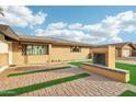 House exterior with brick fireplace and paved walkway at 8214 E Northland Dr, Scottsdale, AZ 85251