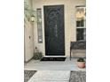 Close up of custom security door with welcome mat and bench at 861 E Toledo St, Gilbert, AZ 85295