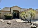 A single story home with desert landscaping and a tile roof at 861 E Toledo St, Gilbert, AZ 85295