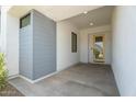 Covered entryway features modern architecture with clean lines and a yellow front door at 1113 E La Mirada Dr, Phoenix, AZ 85042