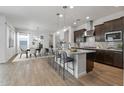 Open-concept kitchen boasts a large island with seating and pendant lighting, flowing seamlessly into the dining area at 1113 E La Mirada Dr, Phoenix, AZ 85042
