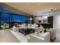 Bright living room with comfortable white sofas, wood ceiling and seamless indoor/outdoor desert views at 38300 N 102Nd St, Scottsdale, AZ 85262
