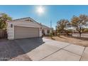 Single-story home with a two-car garage and driveway at 9041 W Virginia Ave, Phoenix, AZ 85037