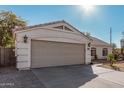 Two-car garage with an attached single-story home at 9041 W Virginia Ave, Phoenix, AZ 85037