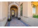 Elegant entryway with arched doorway and brick walkway at 9127 E Lynwood St, Mesa, AZ 85207