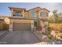 Two-story home with stone accents and a three-car garage at 9127 E Lynwood St, Mesa, AZ 85207