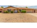 Single story home with well-manicured landscaping and a gravel driveway at 9607 N 41St Dr, Phoenix, AZ 85051