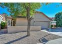Front view of a single-story house with a neutral color palette at 10405 N 65Th Dr, Glendale, AZ 85302