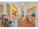 Open kitchen with light wood cabinets and an island at 10555 W Woodruff Rd, Casa Grande, AZ 85194