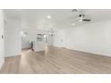 Bright and airy living room with modern flooring and a ceiling fan at 1603 W Alcott St, Mesa, AZ 85201