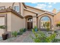 Charming home entrance with a decorative fountain and mature landscaping at 2249 E Taxidea Way, Phoenix, AZ 85048