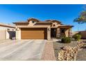 Single-story house with brown garage door and landscaped yard at 26407 N 166Th Ave, Surprise, AZ 85387
