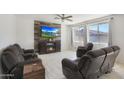 Comfortable living room with reclining sofa, a modern fireplace, and a ceiling fan at 3446 N Mayfair St, Mesa, AZ 85213