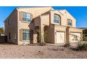 Two-story house with beige exterior, two-car garage, and small front yard at 35834 W Cartegna Ln, Maricopa, AZ 85138