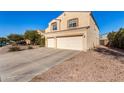 Two-story house with beige exterior, two-car garage, and driveway at 35834 W Cartegna Ln, Maricopa, AZ 85138