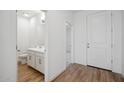 Small half bathroom with white cabinets and wood-look tile floor at 3857 S 233Rd Ln, Buckeye, AZ 85326