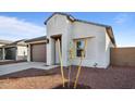 New construction home with neutral exterior and small front yard at 3857 S 233Rd Ln, Buckeye, AZ 85326