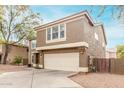Home's front exterior features a concrete driveway, two-car garage, and a stucco facade at 415 W Midland Ln, Gilbert, AZ 85233