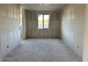 Bedroom showcasing bare walls and a large window for natural light, awaiting personalization at 5510 W Paseo Way, Laveen, AZ 85339