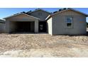 Charming single-story home with a stucco exterior, attached garage, and an unfinished front yard at 5510 W Paseo Way, Laveen, AZ 85339