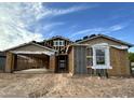 Construction progress of an exterior elevation featuring a two-car garage and modern architectural design at 5510 W Paseo Way, Laveen, AZ 85339